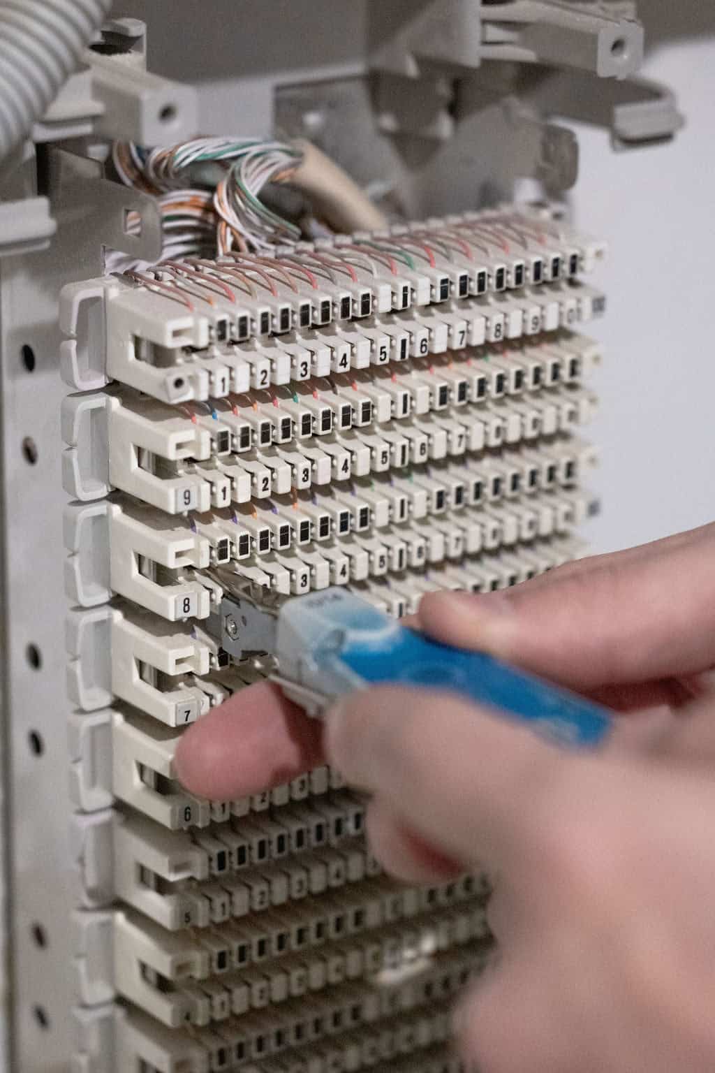 JEN Electrician working on a communications block.