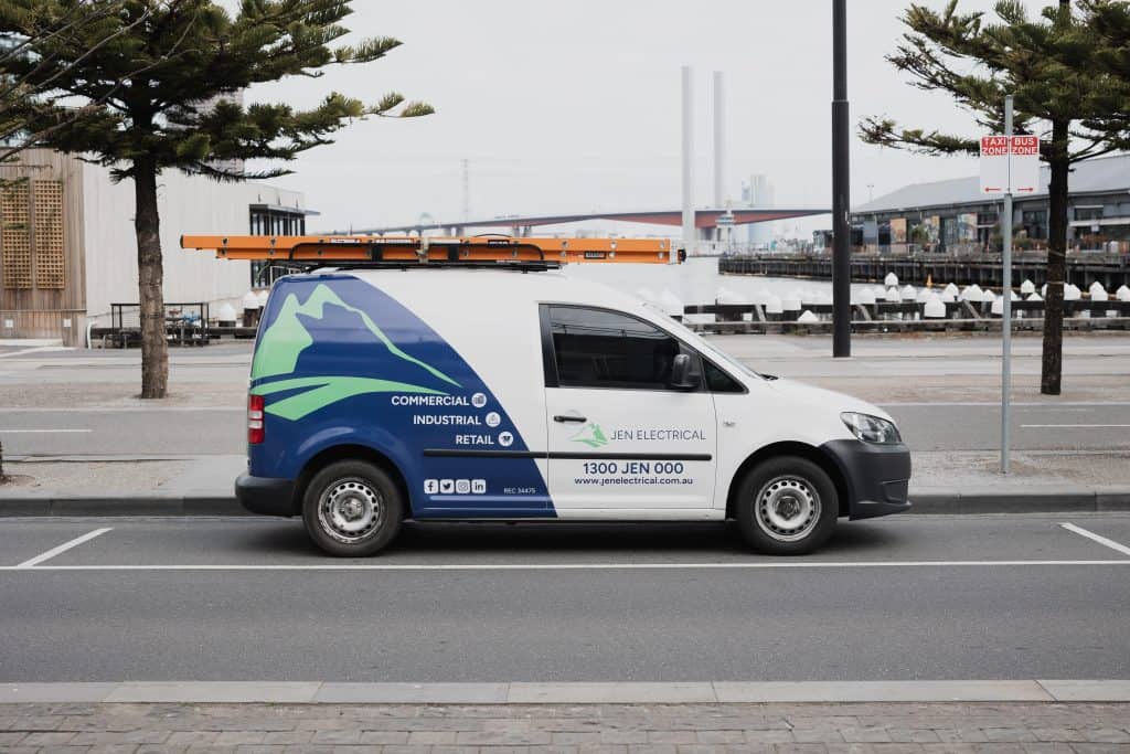 JEN Electrical service van positioned in Melbourne with city skyline background demonstrating local ceiling fan installation coverage across Melbourne metropolitan areas